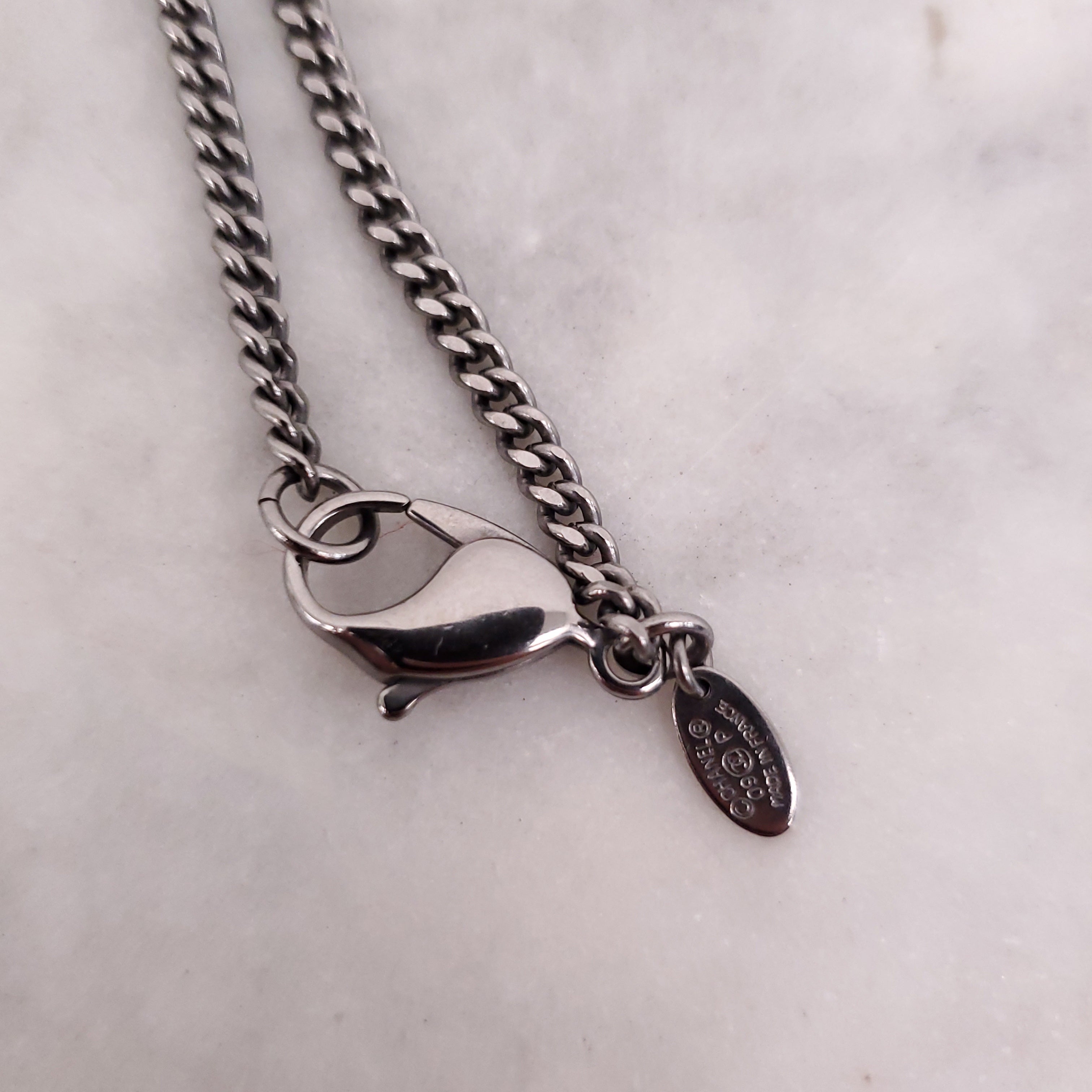 CHANEL BLACK CRYSTAL CROSS WITH LOGO
